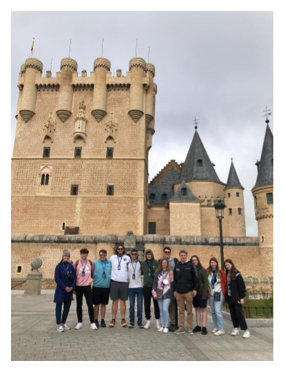 Group of students in spain with castle in background. Pictured (left to right) – Ms. Boghosian, Nicholas Brady, Keiffer Koehl, Simon Thomas, Gage Marshall, Gavin Winn, Lacey Priest, Nicholaus Vedder, Jason Schlotzhauer, Ryan Walker, Makenzie Thomas, and Karly Warner. 